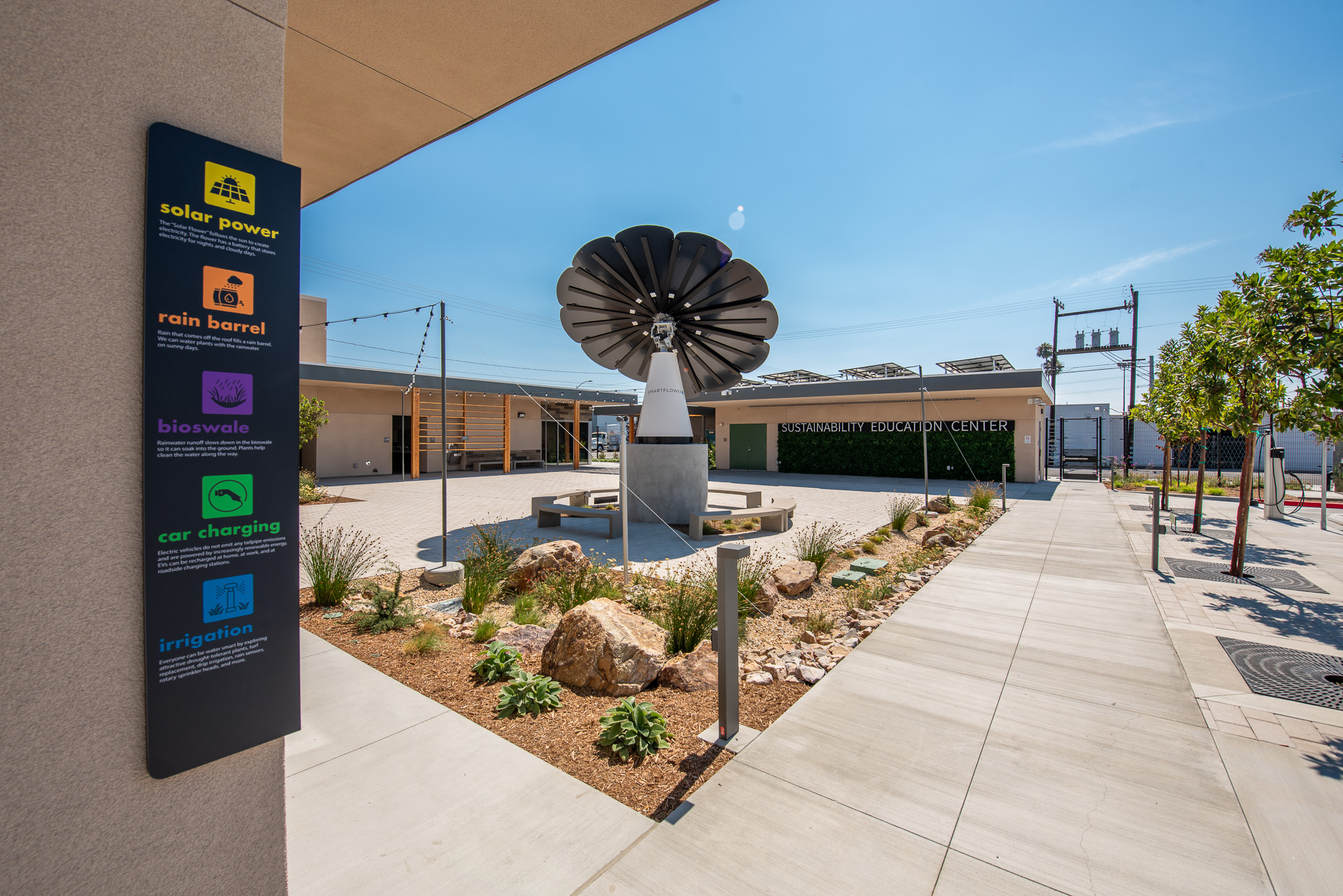 SmartFlower sitting on a concrete podium in the middle of the outdoor educational garden at Anaheim Sustainability Education Center in California