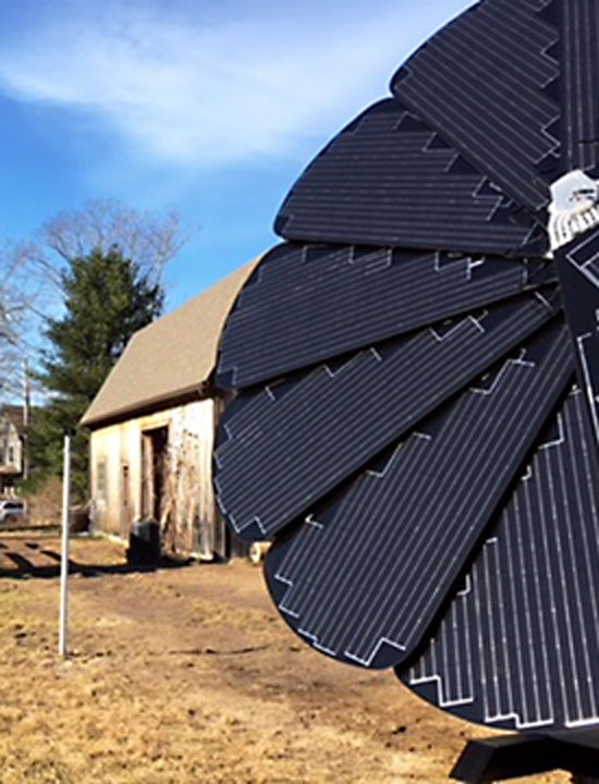 A SmartFlower fully deployed in a rustic farm setting